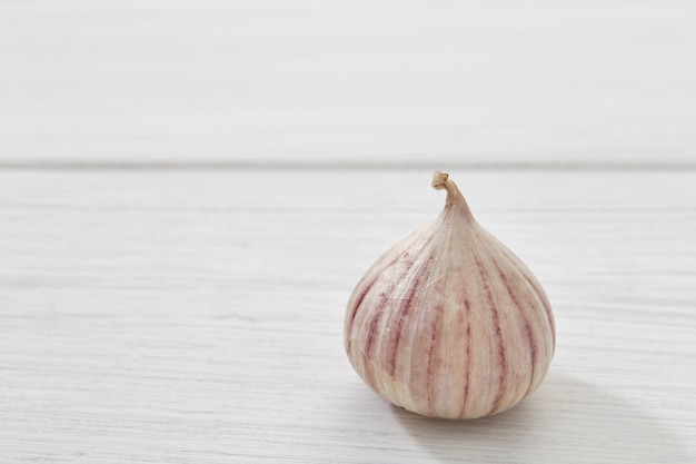 Fresh healthy garlic on white table