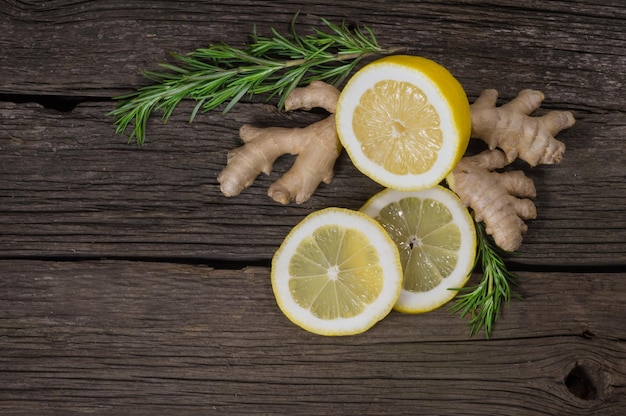 Fresh healthy ginger and ripe lemon on a wooden background top view