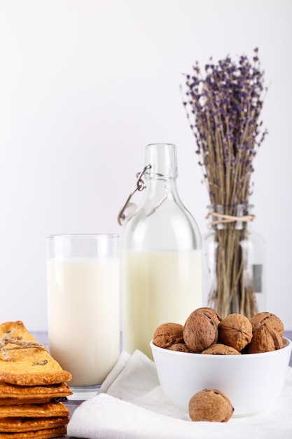 Fresh healthy milk cookies with raisins walnuts bunch of dry cut lavender on white background select