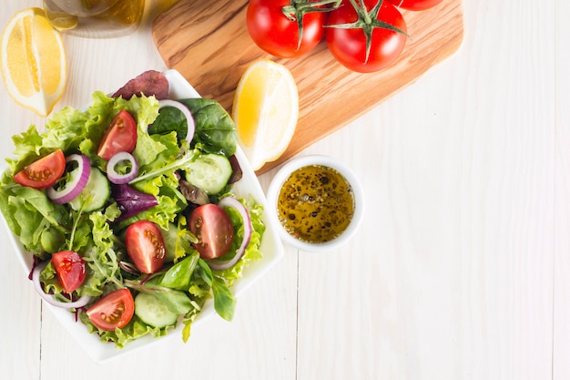 Fresh healthy salad with delicious spinach, feta cheese, red onion, cucumber and cherry tomato