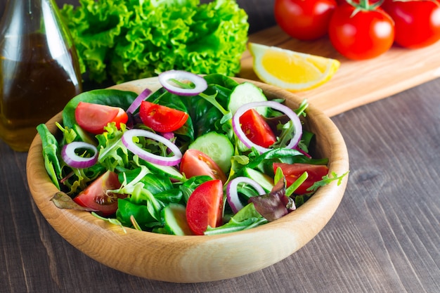 Fresh healthy salad with delicious spinach, feta cheese, red onion, cucumber and cherry tomato