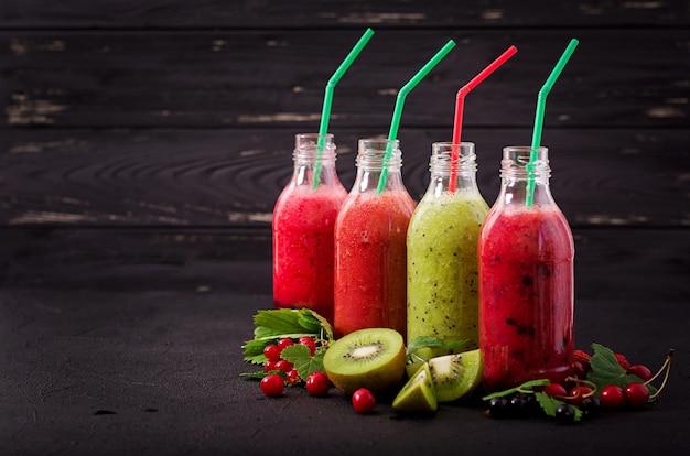 Fresh healthy smoothies from different berries on a dark background. Diet menu.