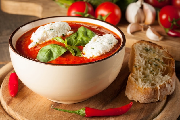 Fresh, healthy tomato soup with basil, pepper, garlic, tomatoes and bread. Spanish gazpacho soup.