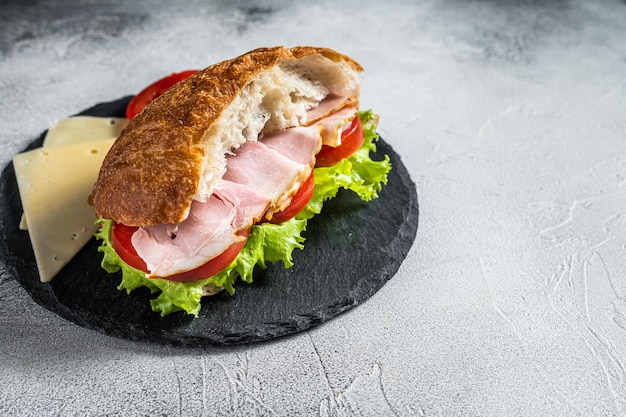 Fresh and healthy turkey sandwich with white cheese tomato and Lettuce in white bread White background Top view Copy space