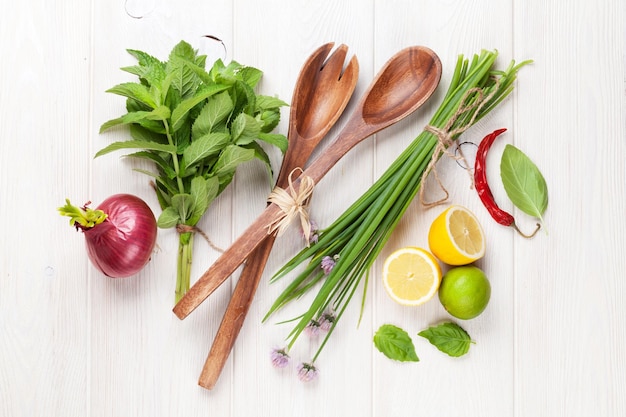 Fresh herbs and spices on wooden table