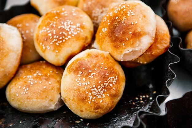 Fresh homemade bread taken from the wood oven Close up of rustic wholemeal bread rolls