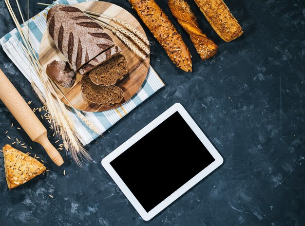 Fresh homemade bread with tablet