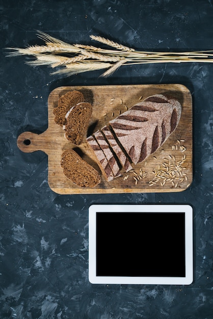 Fresh homemade bread with tablet