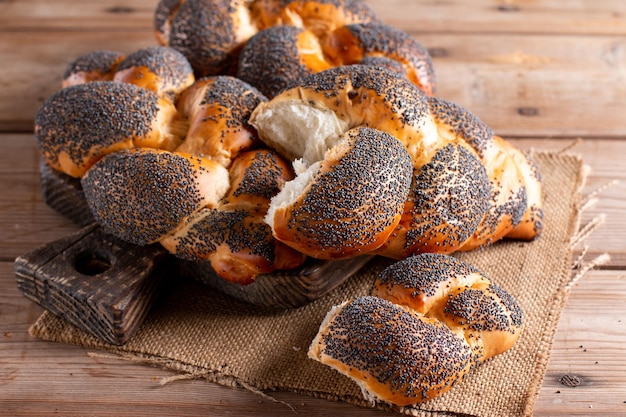 Fresh homemade buns with poppyseed Homemade bread on wooden background