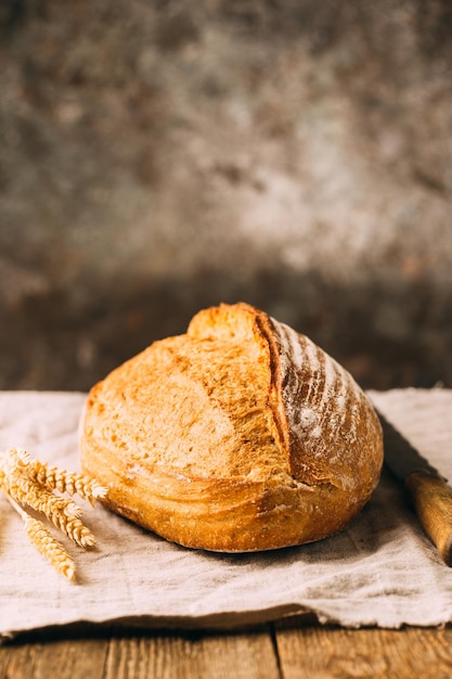 Fresh homemade crisp bread on wooden background. French bread. Bread at leaven. Unleavened bread