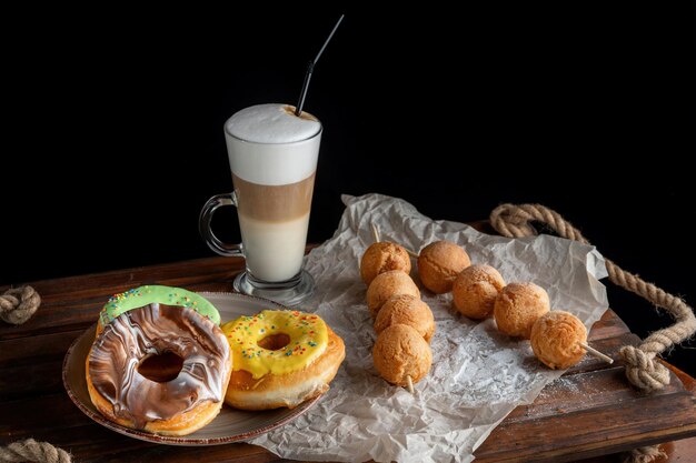 Fresh Homemade Donuts and Coffee against a background Next are cheese balls View under 45