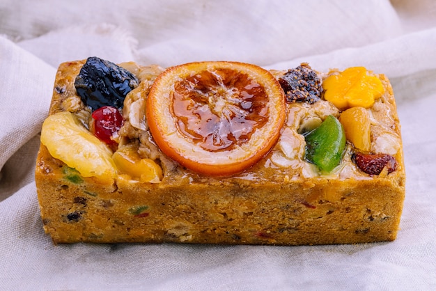 Fresh homemade fruit cake with juicy candied fruits topping