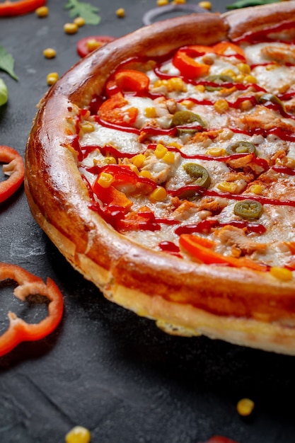 Fresh Homemade Italian Pizza Margherita with olives and red Bulgarian peppers on a dark background