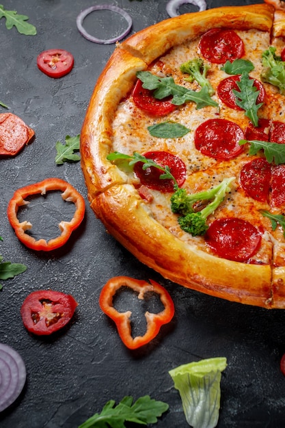 Fresh Homemade Italian Pizza Margherita with olives and red Bulgarian peppers on a dark background