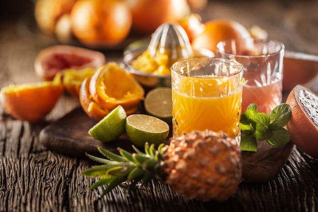 Fresh homemade juices made from oranges and grapefruits in ornamental glasses.