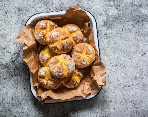 Fresh homemade pumpkin buns on a gray background top view