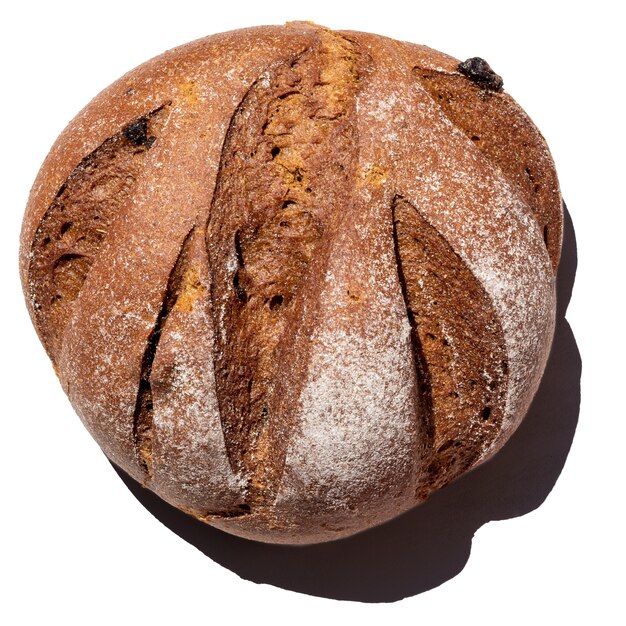 Fresh homemade rustic rye round with raisins bread isolated on white background, top view, close-up. Healthy food concept, the benefits of bread