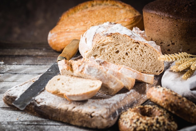 Fresh homemade slice bread and knife on rustic table