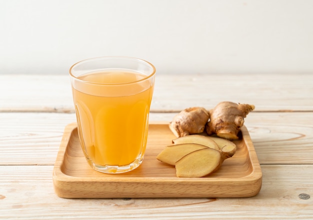 fresh and hot ginger juice glass with ginger roots - Healthy drink style