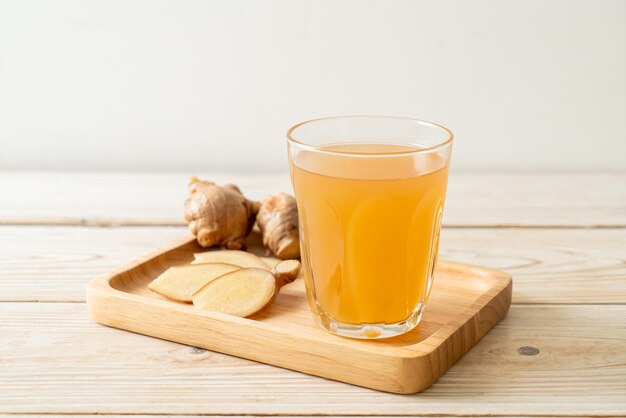 fresh and hot ginger juice glass with ginger roots - Healthy drink style