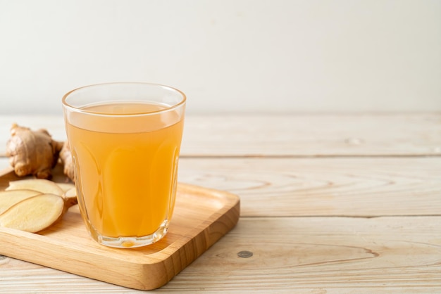 fresh and hot ginger juice glass with ginger roots - Healthy drink style