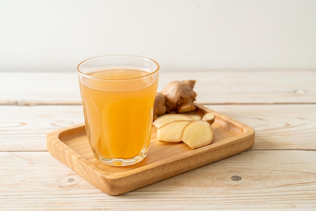 fresh and hot ginger juice glass with ginger roots - Healthy drink style