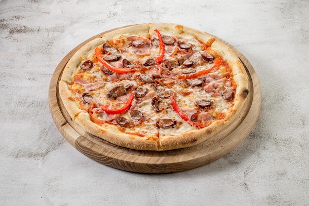 Fresh hot meat pizza on the white concrete background Flat lay