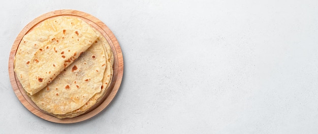 Fresh Indian chapati cakes on a gray background Top view copy space