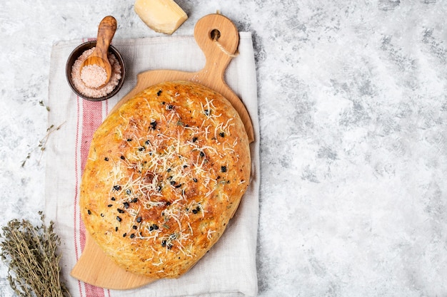 Fresh italian focaccia bread with herbs and olives