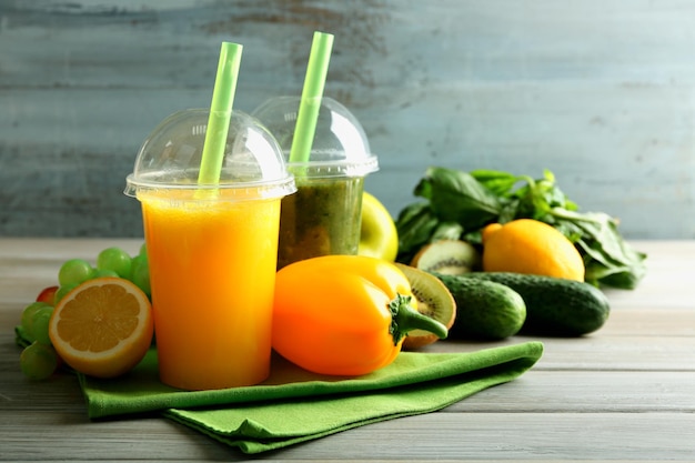 Fresh juice mix fruit healthy drinks on wooden table on bright background