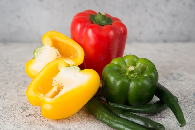 Fresh juicy bell peppers on a gray, close up