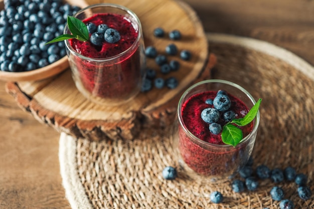 Fresh juicy blueberry smoothies in the glass Simple background Healthy food Detox Lifestyle