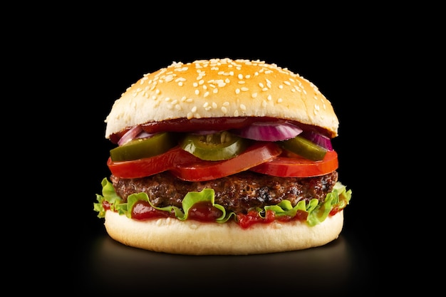 Fresh juicy burger on black background