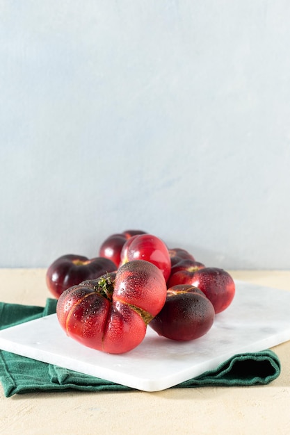 Fresh juicy homemade tomatoes on the kitchen table