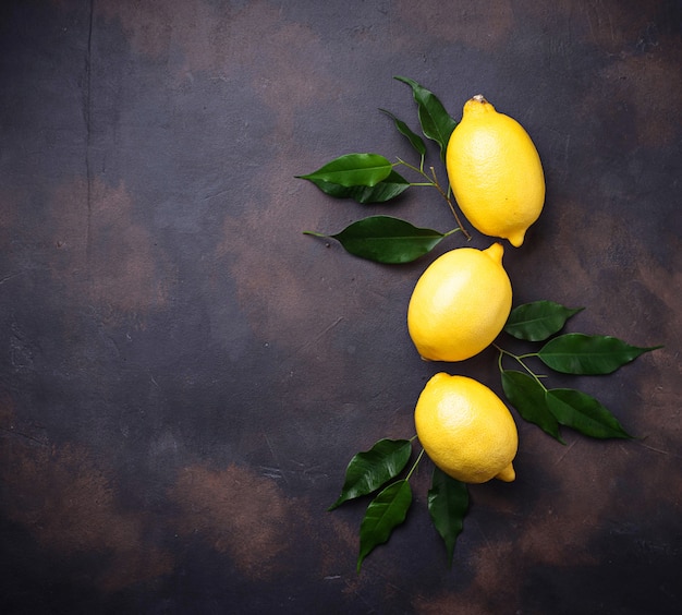 Fresh juicy lemons on rusty background