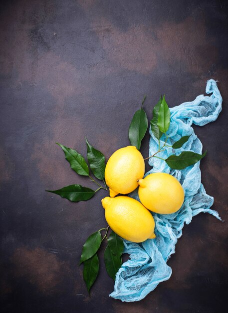 Fresh juicy lemons on rusty background