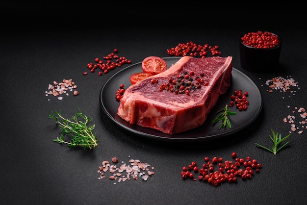 Fresh juicy raw new york beef steak with salt spices and herbs