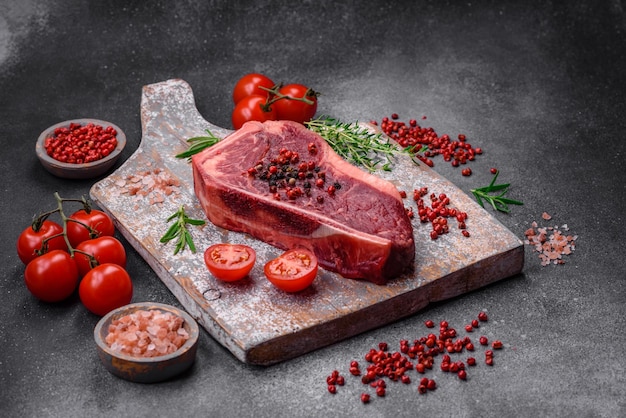 Fresh juicy raw new york beef steak with salt spices and herbs