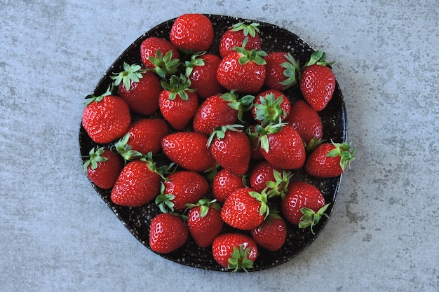 Fresh juicy strawberries on a plate.