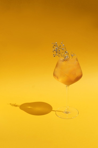 Fresh juicy summer cocktail on yellow background