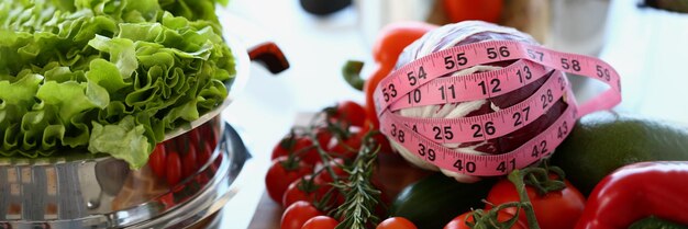 Fresh juicy vegetables with measuring tape closeup