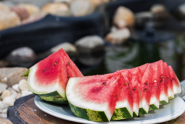 Fresh and juicy watermelon on a platter is cut into even slices