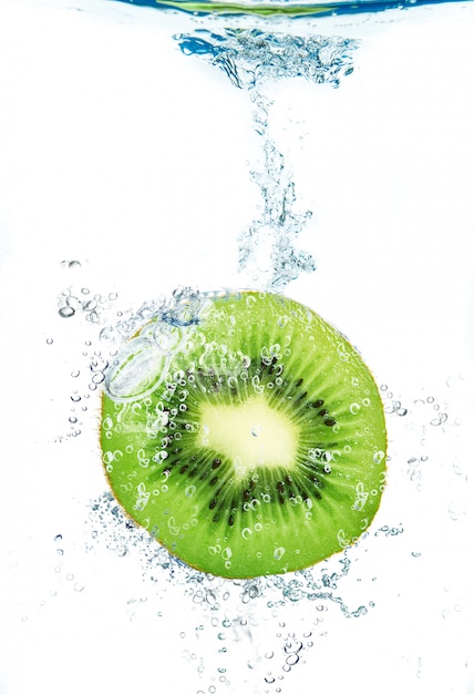 Fresh kiwi falling in water