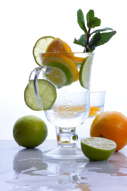 Fresh lemonade cocktail with crushed ice mint leaves and divers oranges Summer cold drink concept Closeup