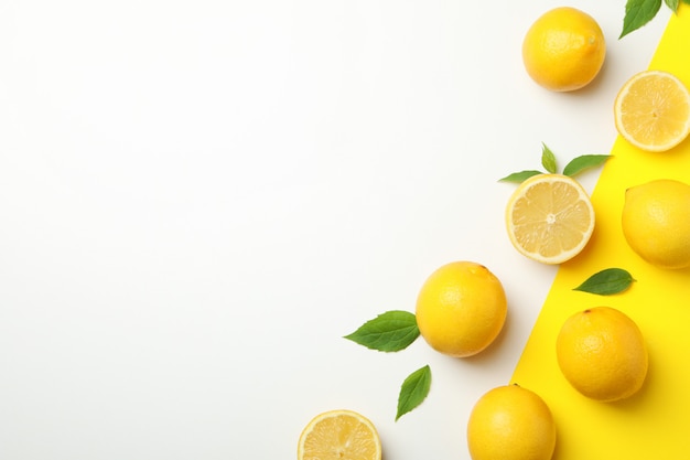 Fresh lemons on two tone table, top view. Ripe fruit