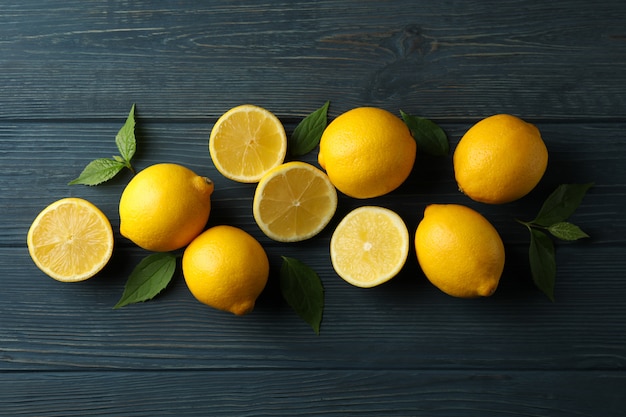 Fresh lemons on wooden surface. Ripe fruit