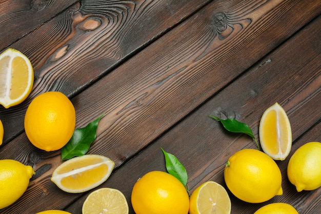 Fresh lemons on wooden table background