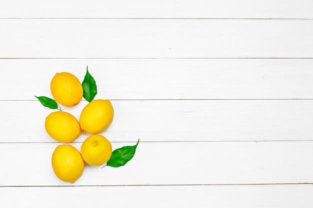 Fresh lemons on wooden table