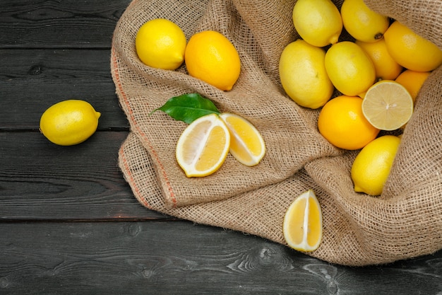 Fresh lemons on wooden table.