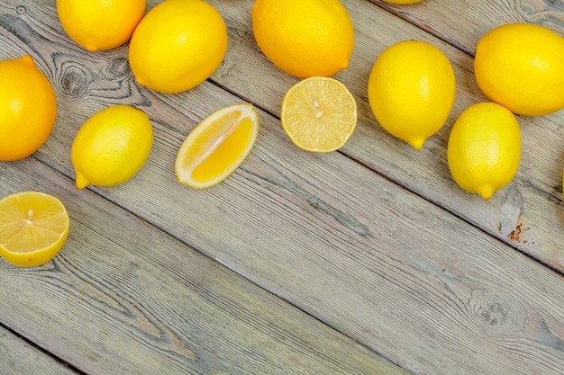 Fresh lemons on wooden table.